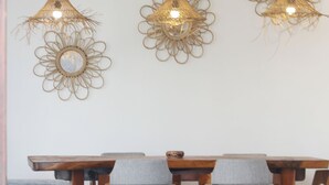 A dining area with a wooden table and grey upholstered chairs.