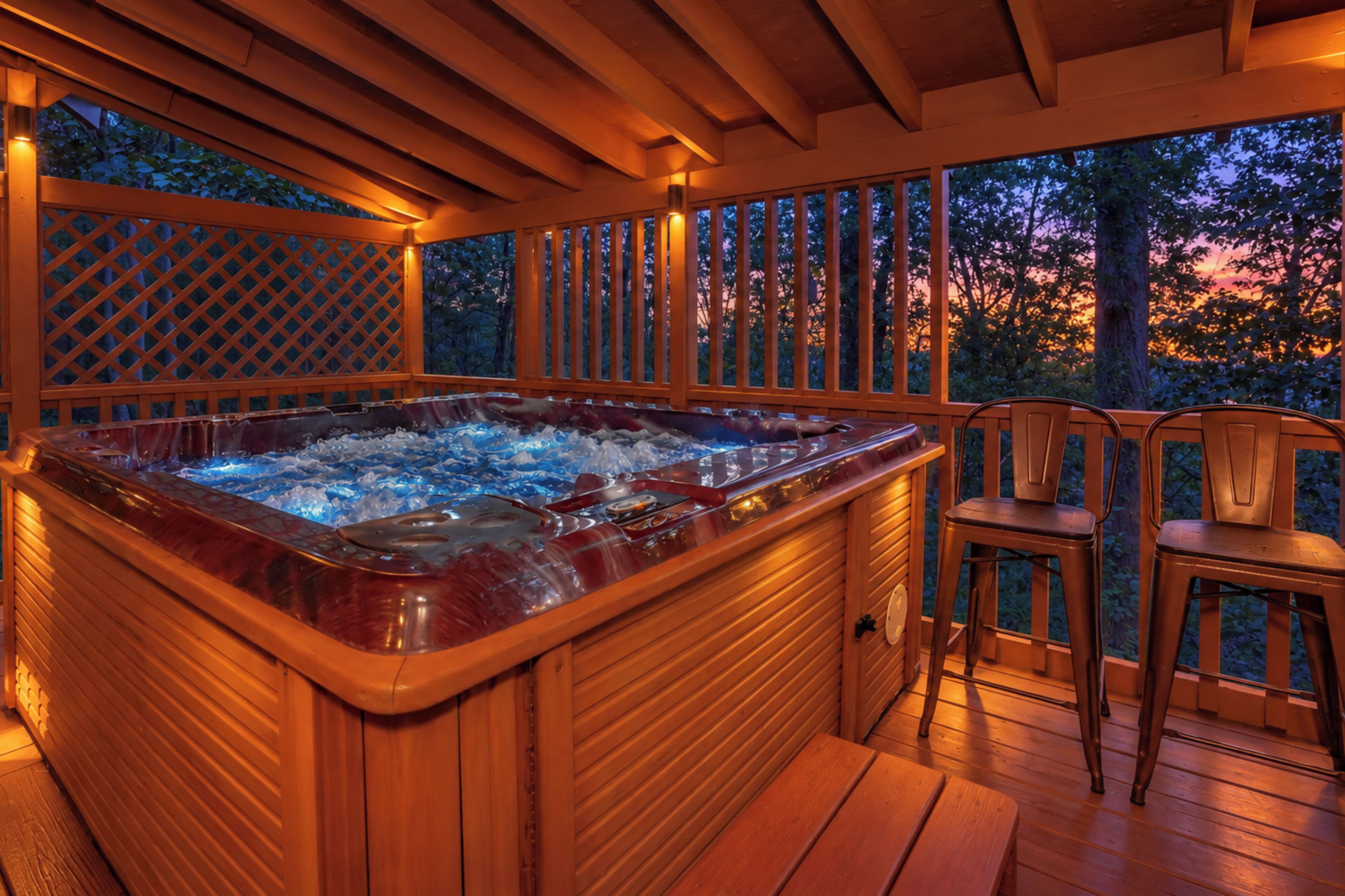 A hot tub on a wooden deck with a view of trees and a sunset.