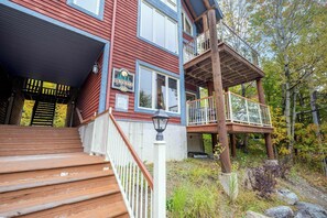 A two-story wooden building with a balcony and a staircase leading to the entrance.