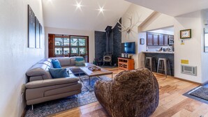 A modern living room with a sofa, coffee table, and a fireplace.