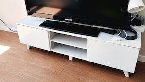 A flat-screen TV on a white entertainment unit. - coex serena residence for business, travel, hospital (Seoul)