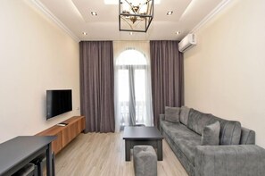 Basic Apartment, Balcony, City View | Living area | 50-inch flat-screen TV with cable channels - Apartments by Luxe Group AM713 (Yerevan)