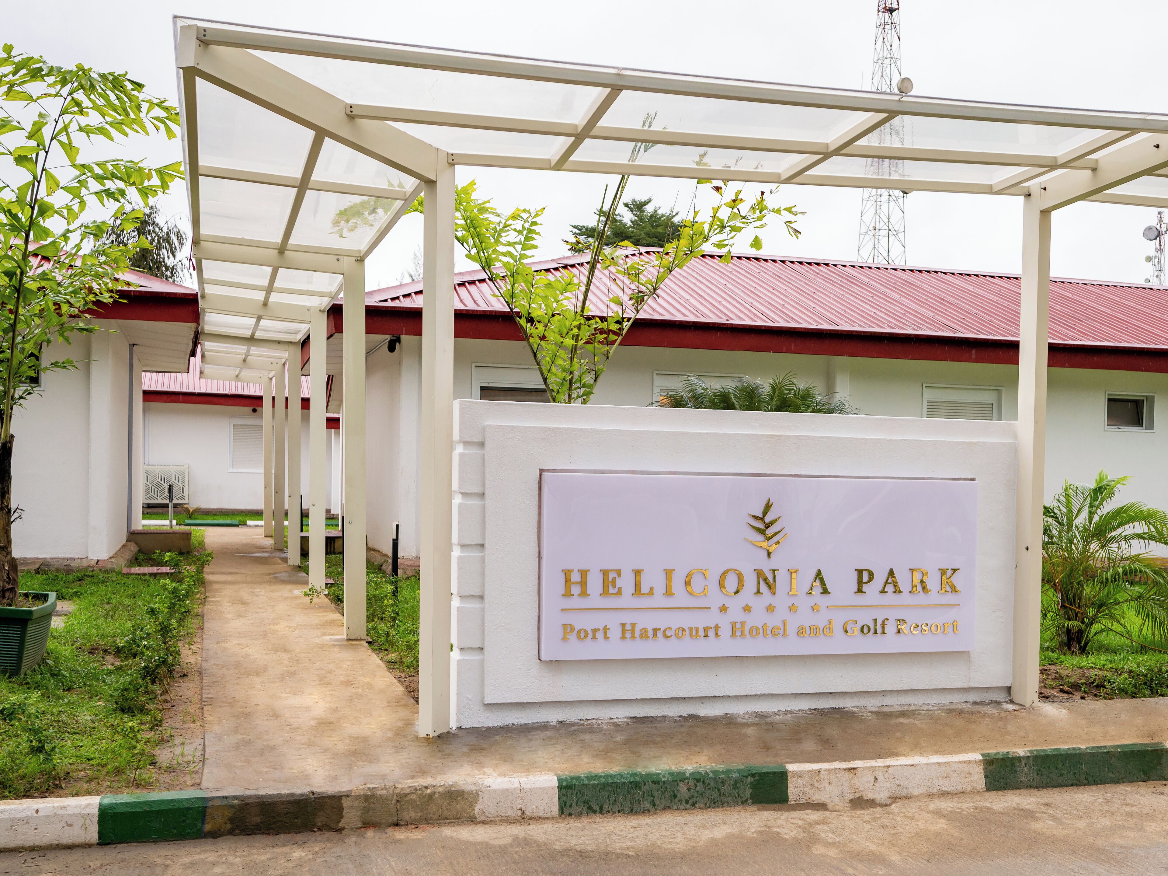 A sign for Heliconia Park, indicating it is a Port Harcourt Hotel and Golf Resort.