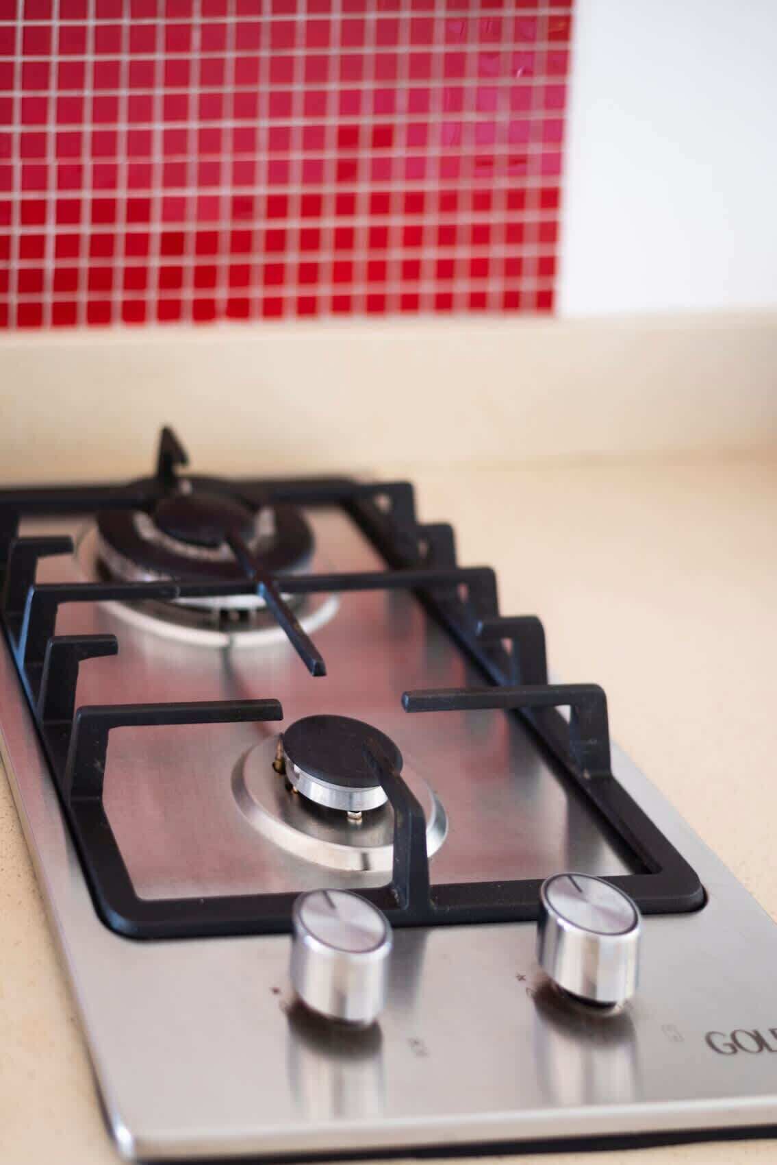 A gas stove with four burners and a control knob.
