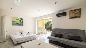 A modern room with a bed, a sofa, a coffee table, and a painting. - A/C House 4br/10p With Pool - 40 min From Cannes (Le Tignet)