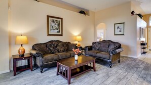 A living room with two sofas, a coffee table, and two lamps.