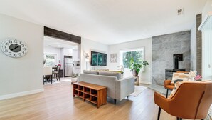 A modern living room with a sofa, coffee table, and a fireplace. - 13 Mi to Lumen Field & Dtwn Seattle! Cozy Retreat (Newcastle)