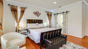 A bedroom with a bed, bedside tables, a chair, a bench, and a mirror. - Take Metro to DC! Family Home in Springfield (Springfield)
