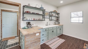 A kitchen with light blue cabinets, a wooden countertop, and a striped rug. - Walk to Historic Square: Jacksboro Home w/ Yard (Jacksboro)
