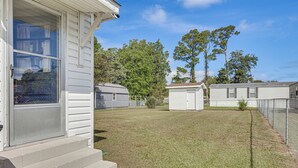 A residential property with a front porch, a small front yard, and a fenced backyard. - 7 Mi to Beach & Ocean! Morehead City Home (Morehead City)