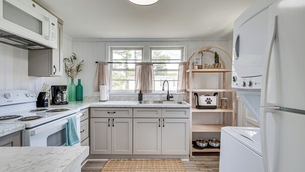 A kitchen with white cabinets, a stove, a sink, and a refrigerator. - 7 Mi to Beach & Ocean! Morehead City Home (Morehead City)