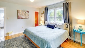 A bedroom with a bed, a nightstand, a lamp, and a window with curtains. - Cozy Home w/ Spacious Yard: 2 Mi to Dtwn Bristol (Bristol)