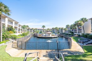 A resort with a central water feature, connected walkways, and multiple balconies. - 3BR Poolside Condo Near Beach (St. Augustine)