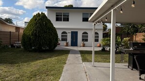 A two-story house with a covered patio and a well-maintained lawn. - Private duplex (second floor) centrally located to beaches and the city of Miami. (Miami)