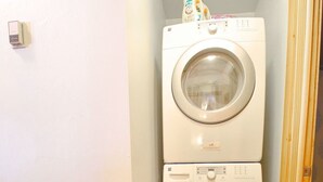 A compact laundry room with two stacked front-loading washing machines. - Townhome in Crested Butte | 2 Bedroom | Walk to Elk Ave | Parking (Crested Butte)