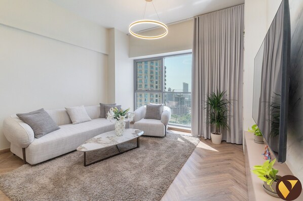 Luxury Apartment, Balcony, City View | Living area | 65-inch Smart TV with satellite channels - JVC near Circle Mall with full Amenities (Dubai)