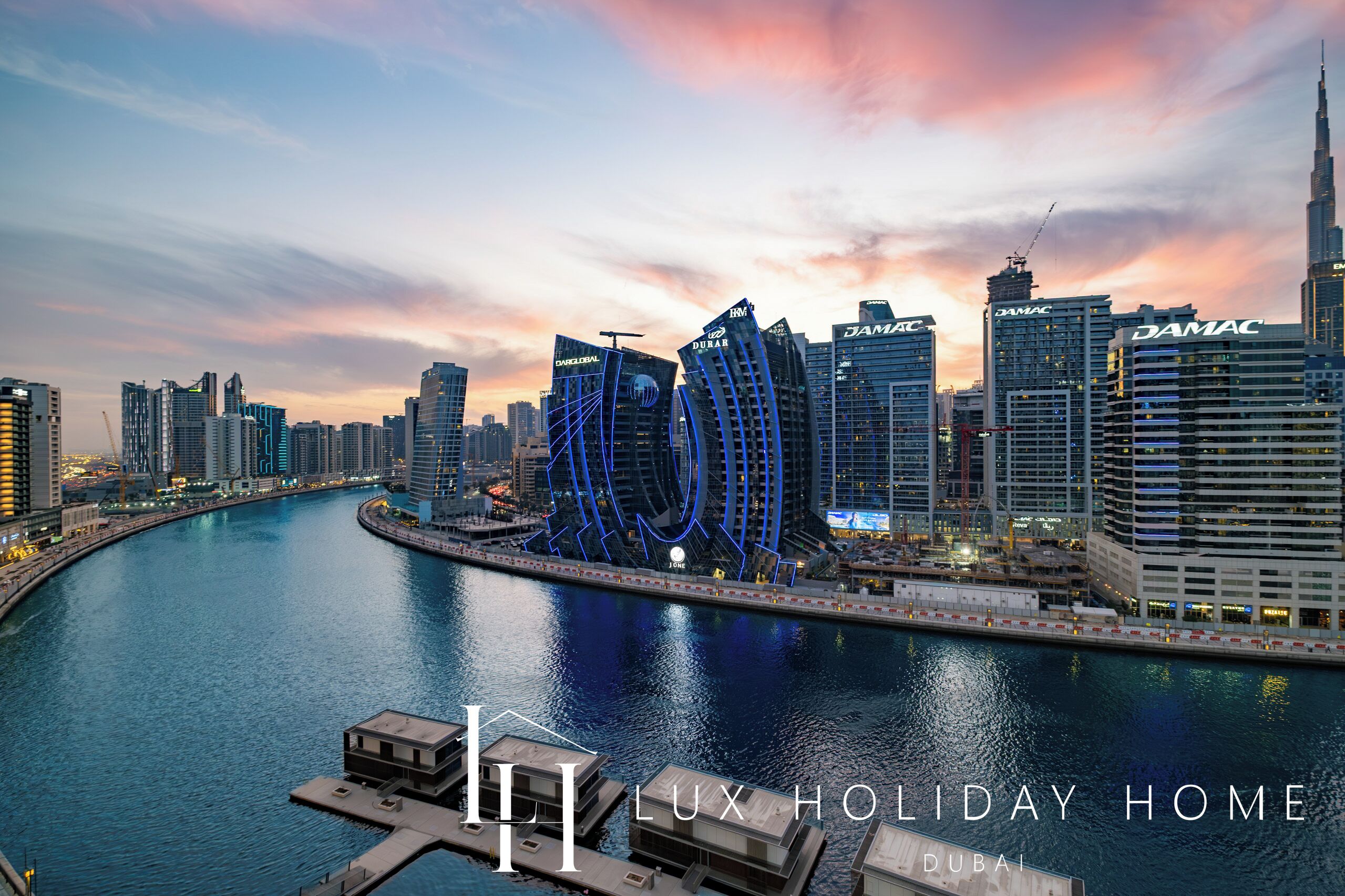A waterfront view of Dubai's skyline with prominent buildings like DAMAC and DAS GLEN.
