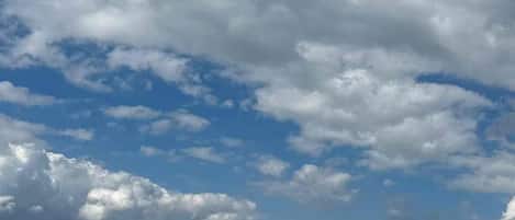 A beach with a clear sky and clouds.