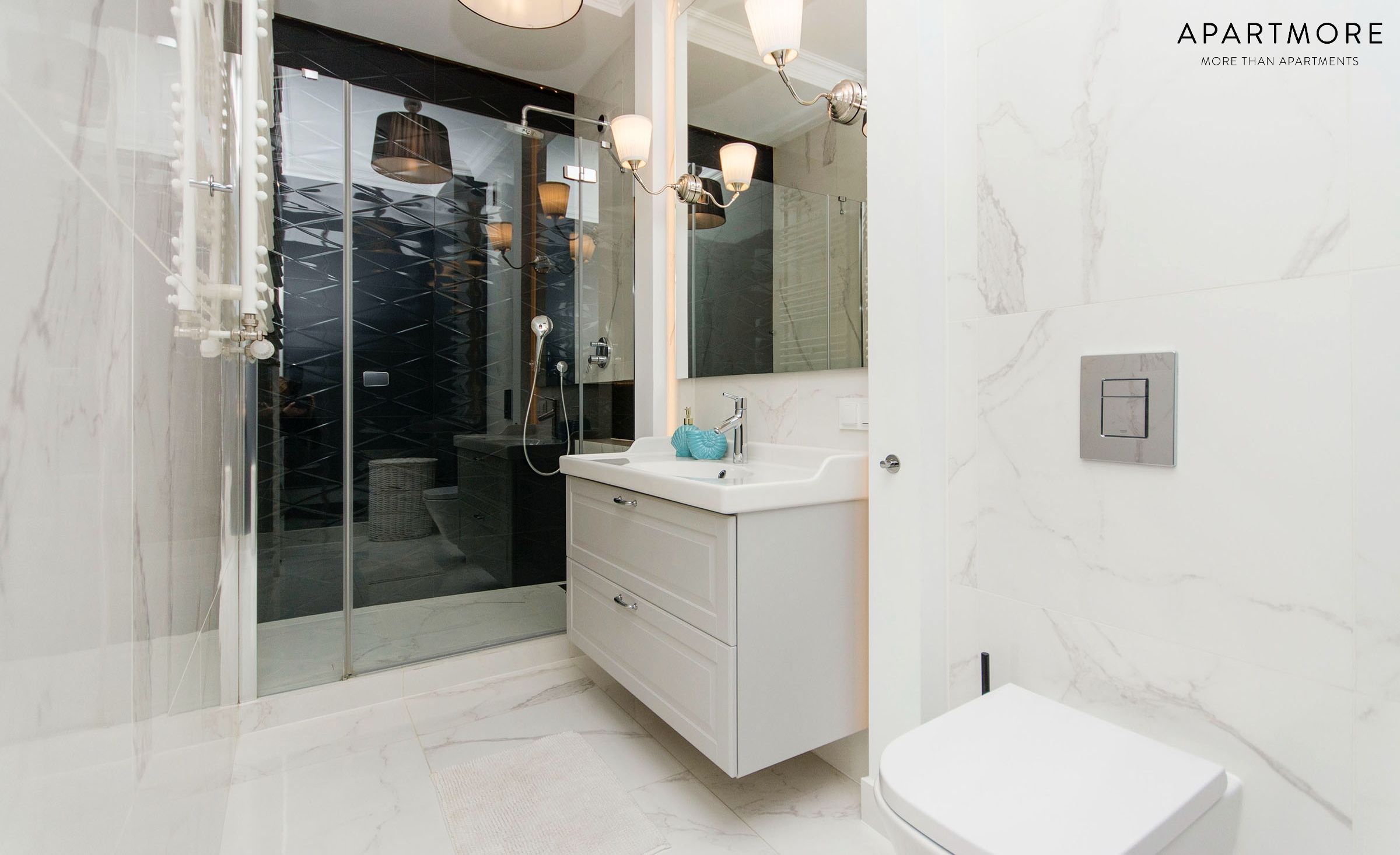 A modern bathroom with a glass shower enclosure, a white vanity with a mirror, and a white toilet.