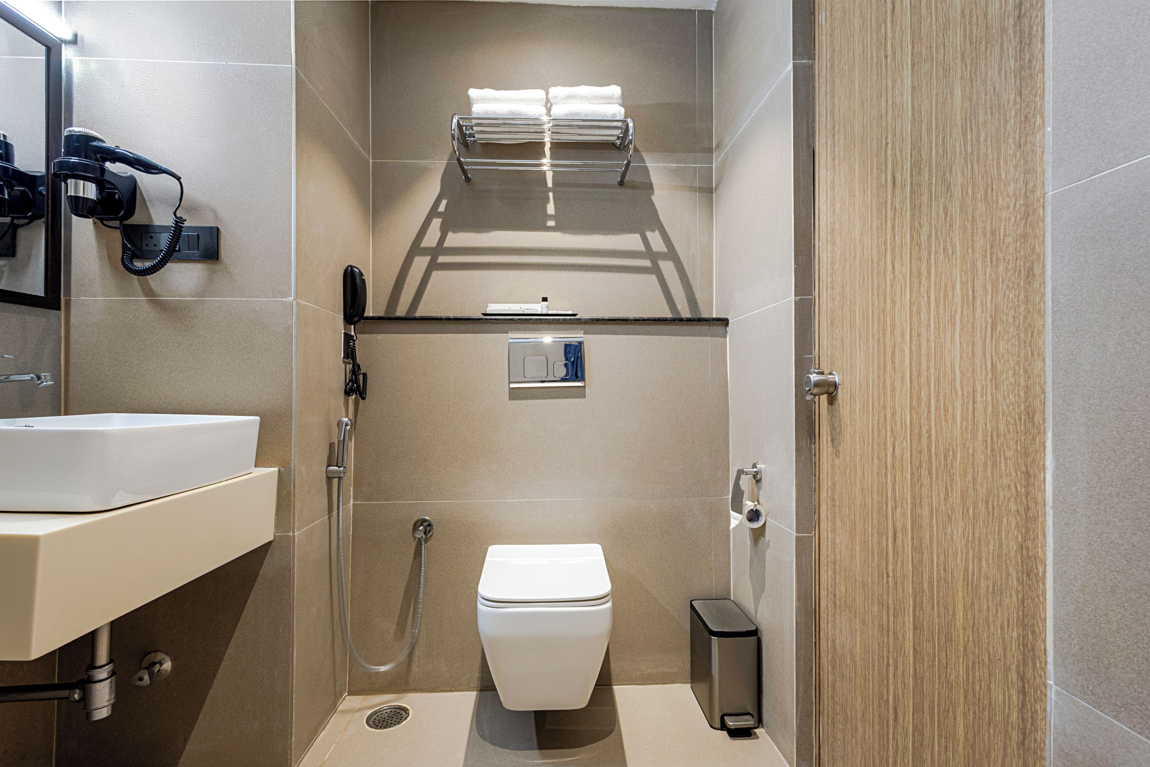 A modern bathroom with a toilet, sink, and shower.