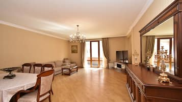 Family Apartment, 4 Bedrooms, Balcony | Living area | 50-inch flat-screen TV with cable channels