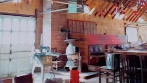 An interior with exposed wooden beams, a dining area with tables and chairs, and hanging colorful lanterns. - Ahrens Rd Ranch (Parksville)