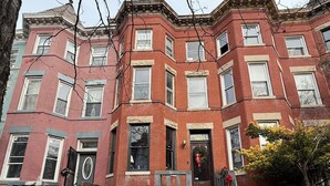 A multi-story red brick building with a central entrance, steps leading up to it, and a small garden area with a tree. - 1BR Bloomingdale Retreat with Private Entry. Walkable & Quiet Neighborhood.   (Washington)