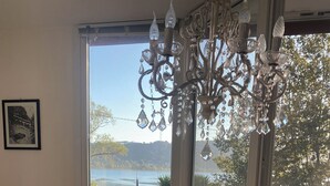 A dining table with a floral tablecloth, a potted lemon tree, and a wicker basket with lemons. - The Lake House (Castel Gandolfo)
