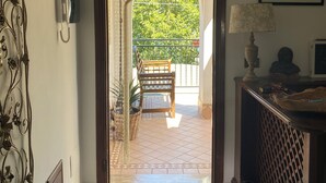 A home entrance with a 'Love Laugh Live' sign, a bench outside, and a 'HOME' mat at the door. - The Lake House (Castel Gandolfo)