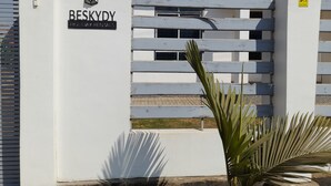 A gated entrance with a sign reading "BESKYDY HOLIDAY RENTALS".