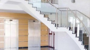 A modern interior with a glass staircase, elevators, and a polished floor. - Luxury penthouse with swimming pool, jacuzzi and gym near the spa of archena (MC)