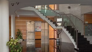 A modern interior with a glass staircase, a reception area, and potted plants. - Luxury penthouse with swimming pool, jacuzzi and gym near the spa of archena (MC)