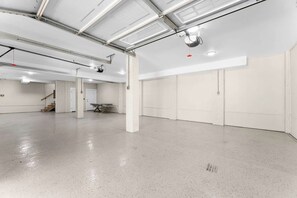 A spacious indoor area with a polished concrete floor, white walls, and a high ceiling with exposed ductwork. - Luxurious 6 Bedroom House Across From Beach! (Isle of Palms)