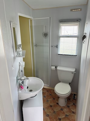 Shower, hair dryer, soap, toilet paper