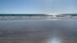 A beach with clear skies and calm waves. - Spacious Top-Floor Condo w/beach access & Intracoastal Views (Indian Shores)