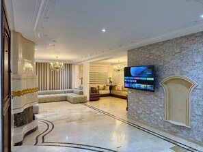 Deluxe Apartment, Balcony, City View | Living area | 150-cm Smart TV with satellite channels