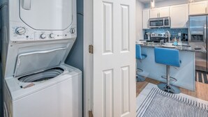 A modern kitchen with white cabinets, a microwave, and a stainless steel refrigerator. - OTR by TQL+Smart TVs+King Bed+Wifi+Sleeps 3+1st Fl (Cincinnati)
