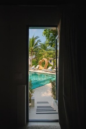 A view of a swimming pool area with lounge chairs and palm trees. - TULUM Koh Samui (Koh Samui)