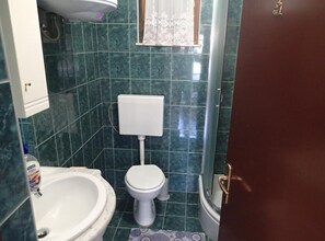 A small bathroom with a toilet, sink, and shower. - Apartments Marija Kruševo A2+2 (Kruševo)