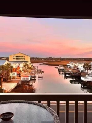 A waterfront view with a building and docked boats. - A Place at the Beach 3B 2/2 ocean blvd pool (North Myrtle Beach)