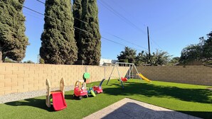 A playground with a slide, swings, and a climbing structure.