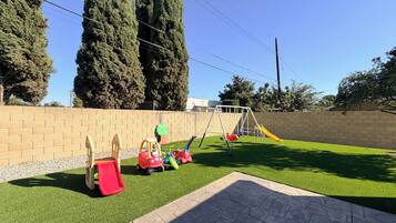A playground with a slide, swings, and a climbing structure.