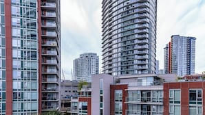 A modern high-rise building with multiple balconies and large windows. - Downtown Vancouver Condo, Pool, Gym, Skytrain (Vancouver)