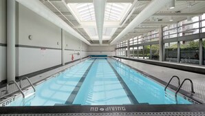 An indoor swimming pool with clear lanes, a no diving sign, and a skylight ceiling. - Downtown Vancouver Condo, Pool, Gym, Skytrain (Vancouver)