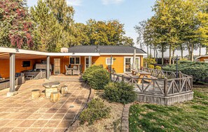 A house with a patio, outdoor seating, and a wooden deck. - 3 bedroom stunning home in Erm (Erm)
