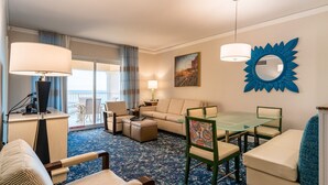 A hotel room with a sofa, a glass dining table, a coffee table, a lamp, a large mirror, and a view of the outdoors. - 2-bedroom resort in delightful Myrtle Beach with AC, fitness room (Myrtle Beach)