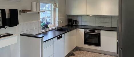 Fridge, stovetop, dishwasher, coffee/tea maker