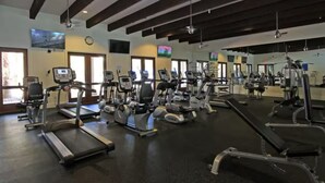 A gym with treadmills, stationary bikes, and weight machines.