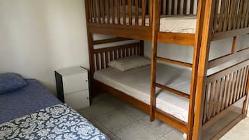 A bunk bed with a lower bunk and a single bed with a patterned bedspread.