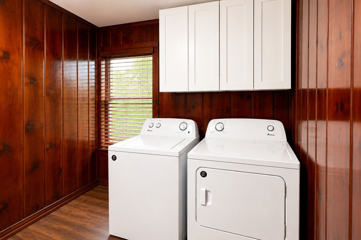 Convenient in-home laundry room with full-size washer, dryer, and storage